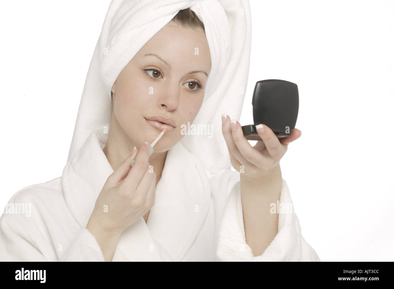 Woman applying lip gloss Stock Photo