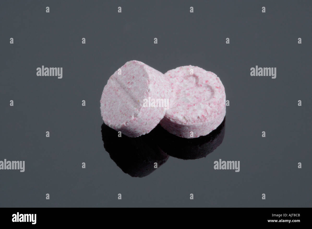 Pink coloured Ecstasy tablet illegal drugs Pills Stock Photo