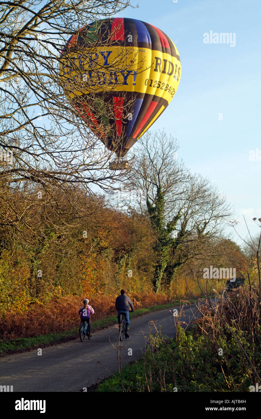 Hot Air Balloon on Autumnal Flight passing over cyclists and the