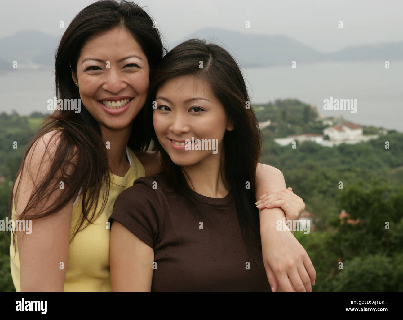 Portrait of two young women smiling Stock Photo - Alamy
