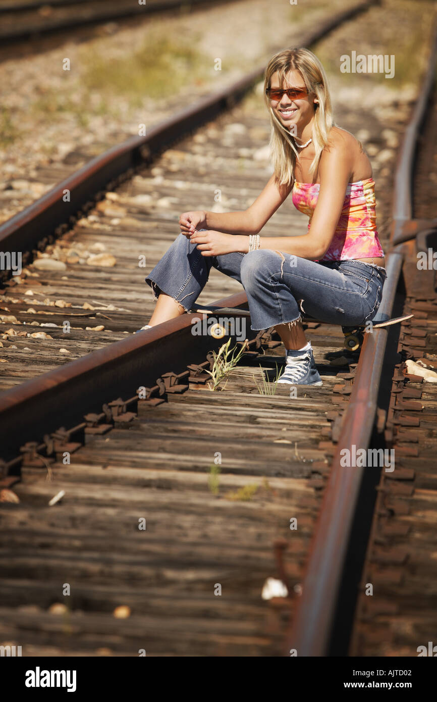 Woman Sitting On Train Tracks Stock Photo Alamy