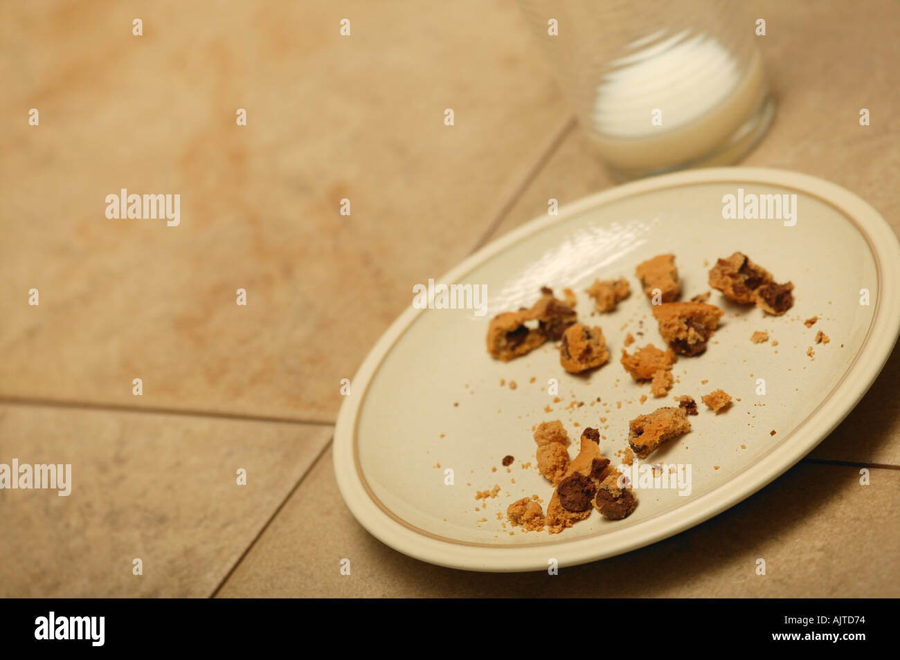 Plate of cookie crumbs and empty glass Stock Photo Alamy