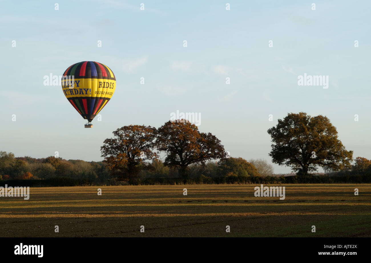 Hot Air Balloon on Autumnal Flight passing over farmland and the English countryside in Hampshire Stock Photo