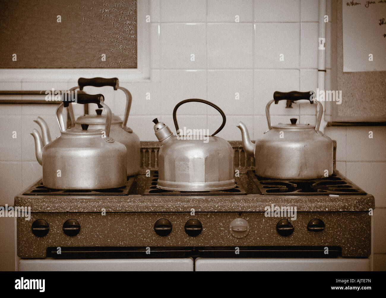 old fashioned kettles and teapots on large cooker top Stock Photo Alamy