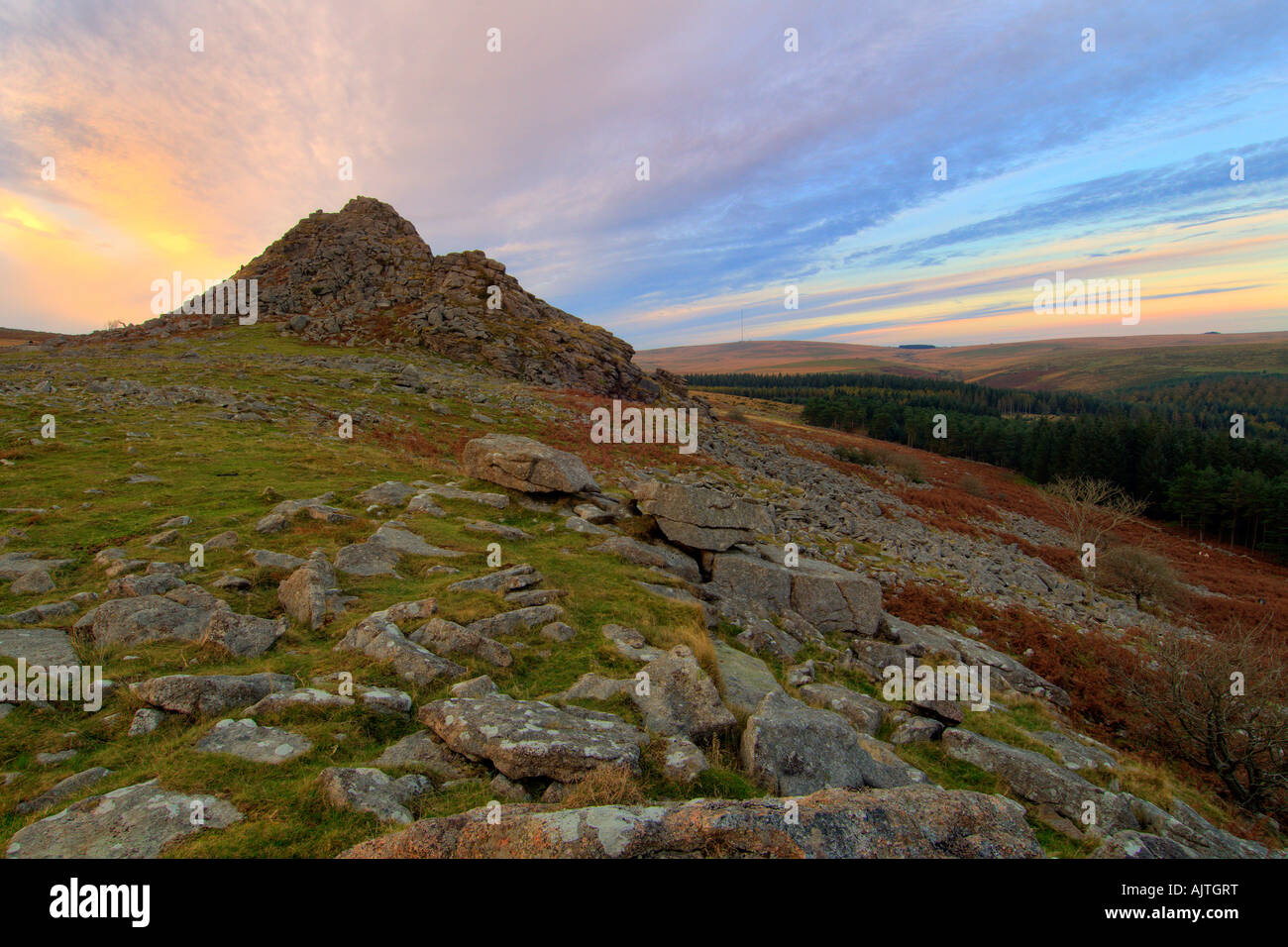 Sunset on Leather Tor on Dartmooor looking across the moor towards Princetown on the horizon Stock Photo