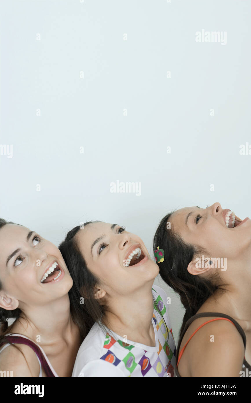 Three young female friends tilting heads back, laughing, head and  shoulders, portrait Stock Photo - Alamy, image size:867x1390