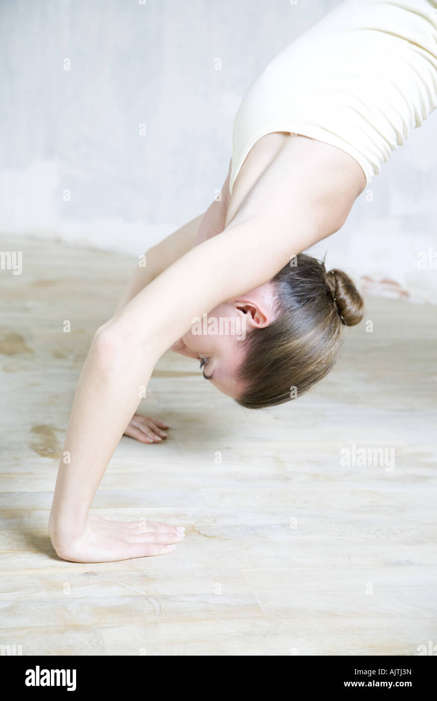 Cropped view of woman doing backbend, waist up Stock Photo
