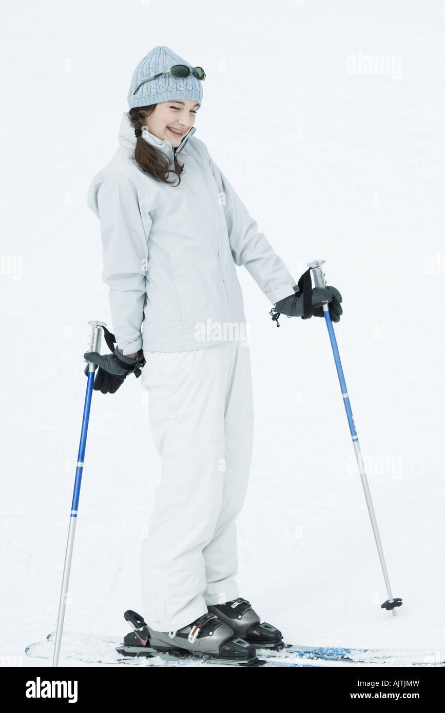 Teen girl wearing skis, smiling Stock Photo