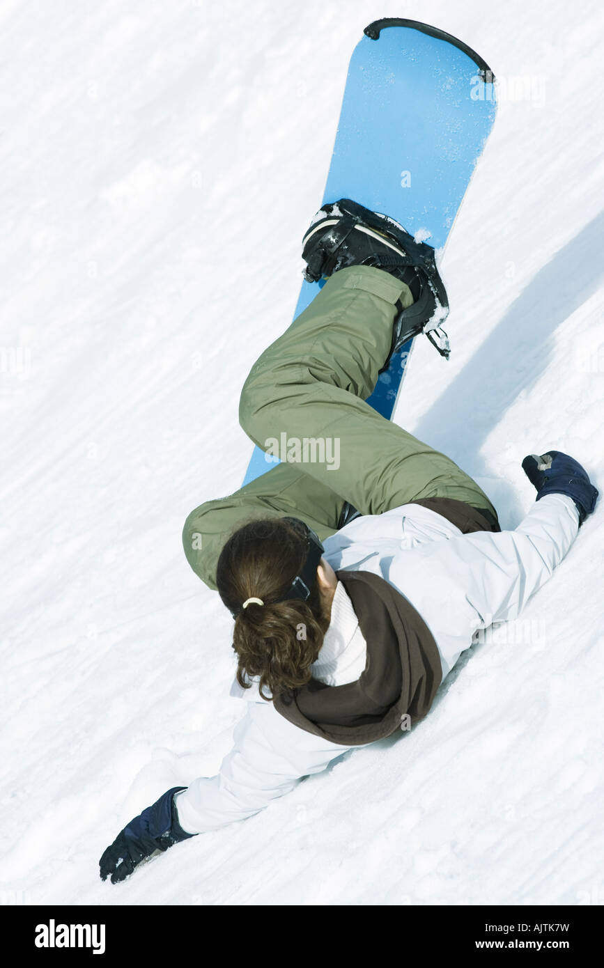 Young snowboarder falling down ski slope, rear view Stock Photo - Alamy
