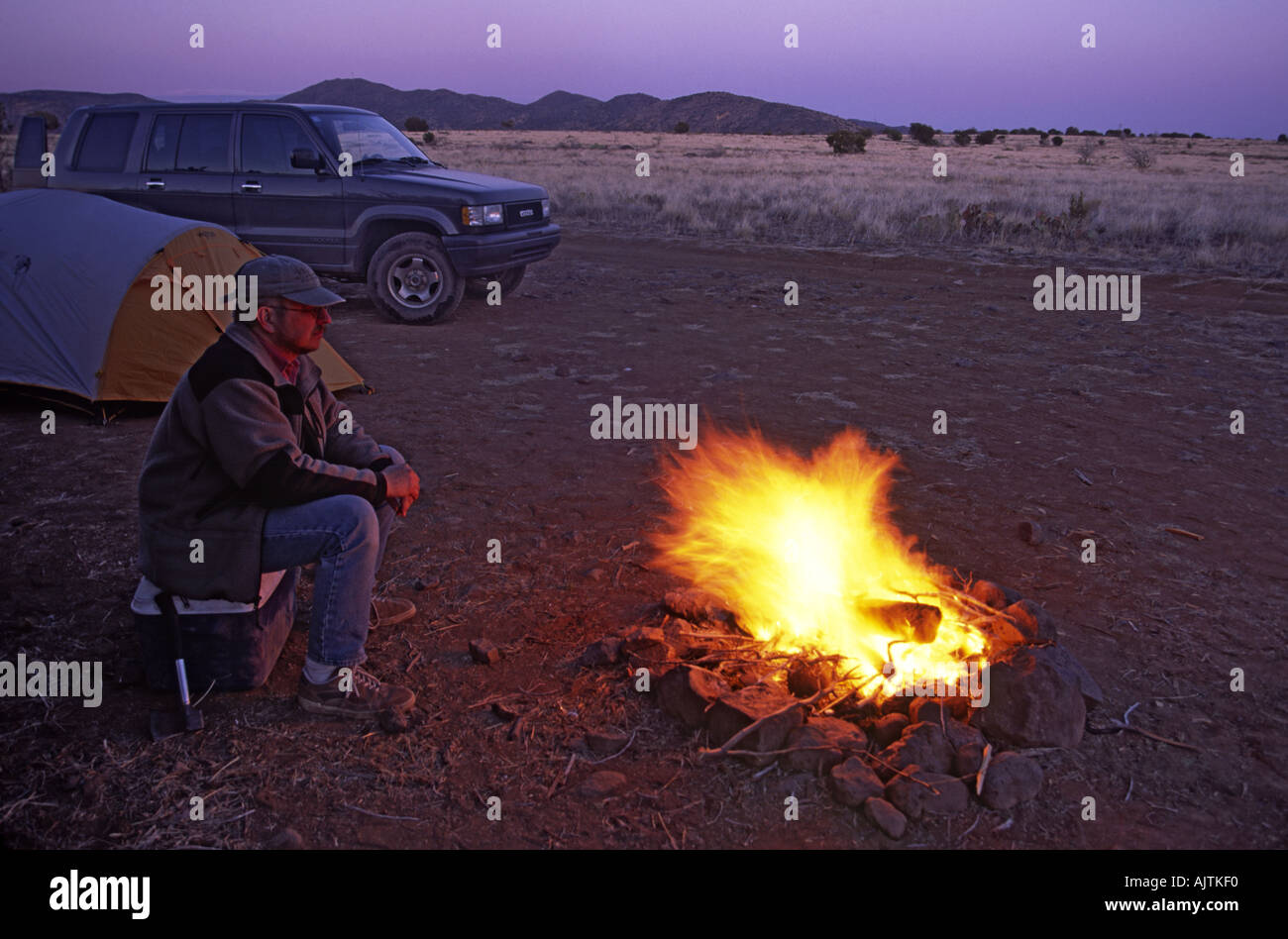 Sitting at campfire at Perry Mesa, South Campbell Tank, Tonto National Forest, Arizona, USA Stock Photo