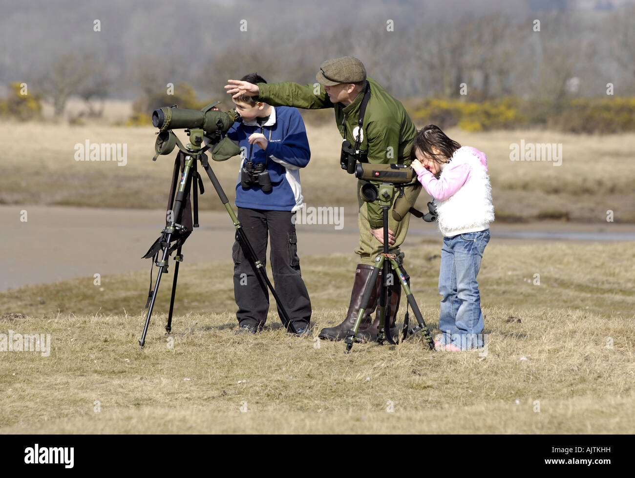 Bird watching on scottish island ISLAY  man and children with binoculars Stock Photo