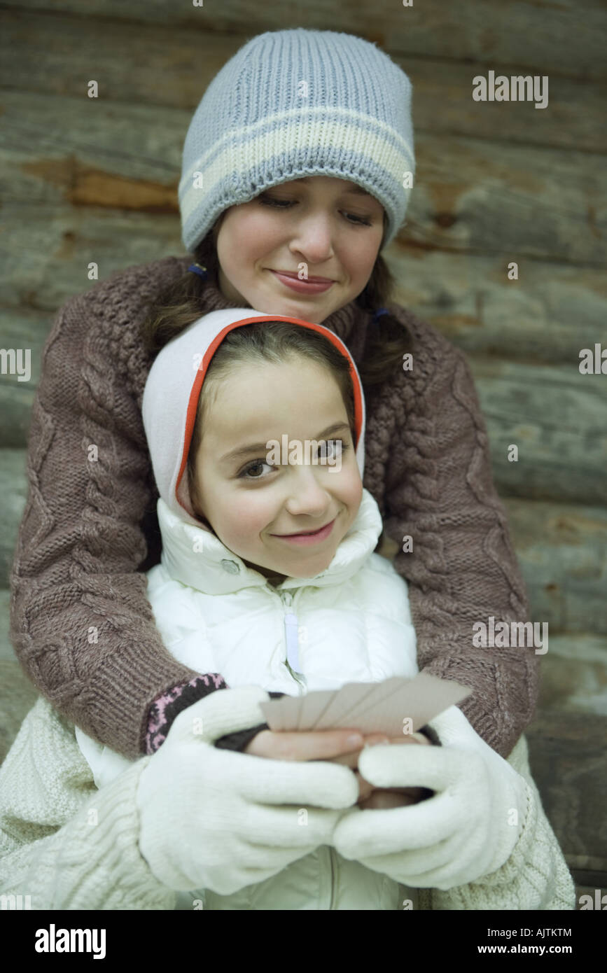 Teen girl holding one arm up and one arm down hires stock photography