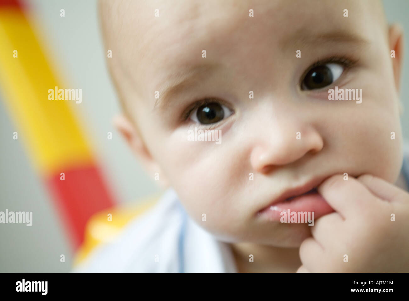 Baby with finger in mouth, close-up Stock Photo