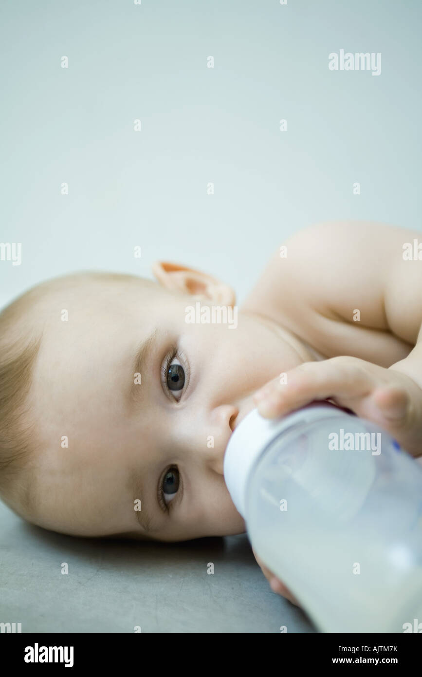 Baby lying down, drinking from bottle Stock Photo Alamy