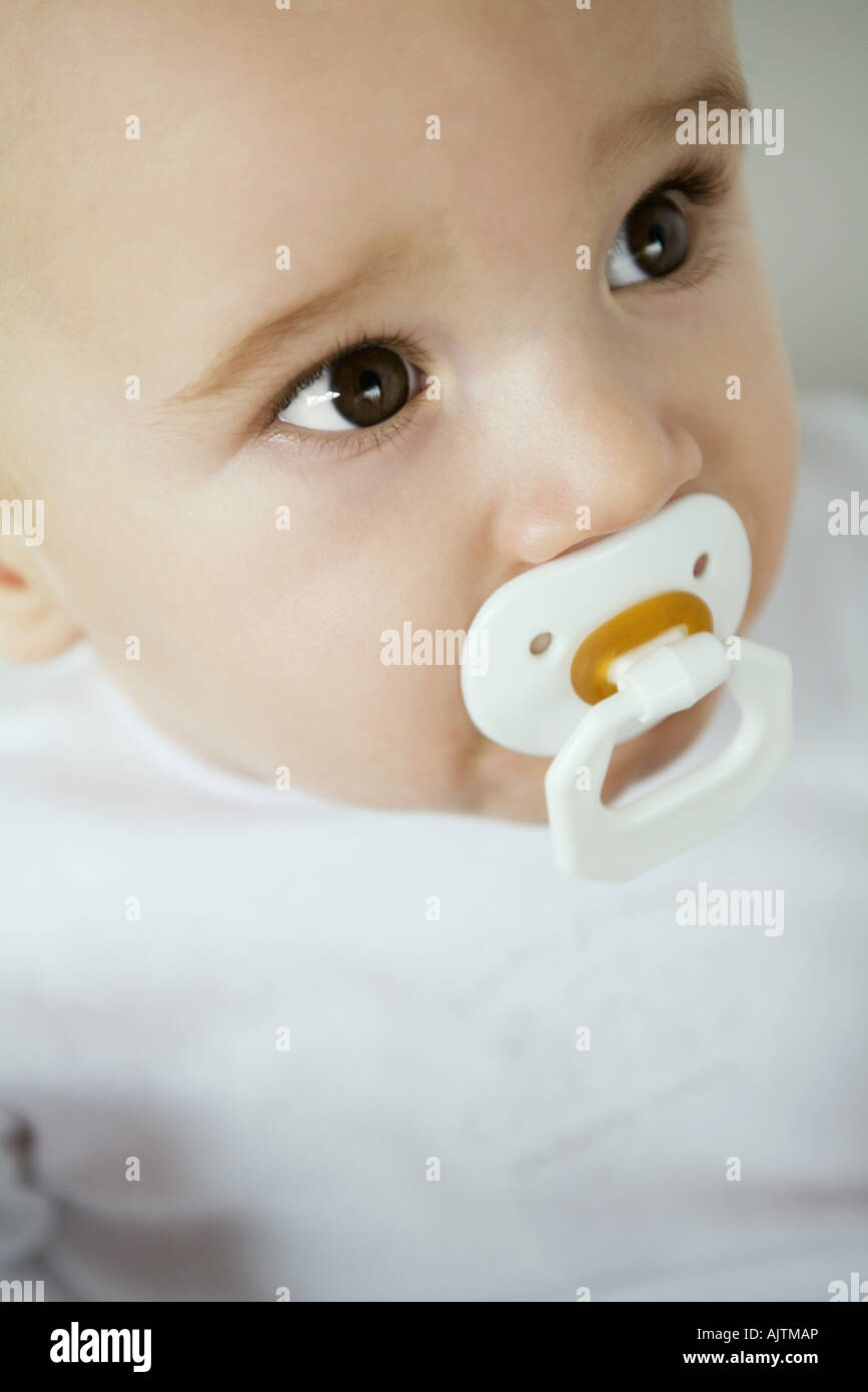 Baby with pacifier in mouth, close-up Stock Photo