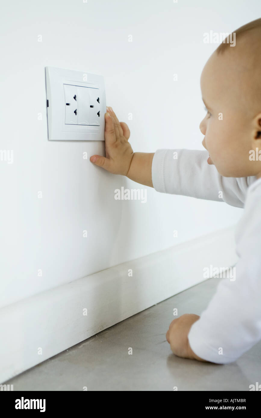 Baby reaching for electrical outlet Stock Photo Alamy