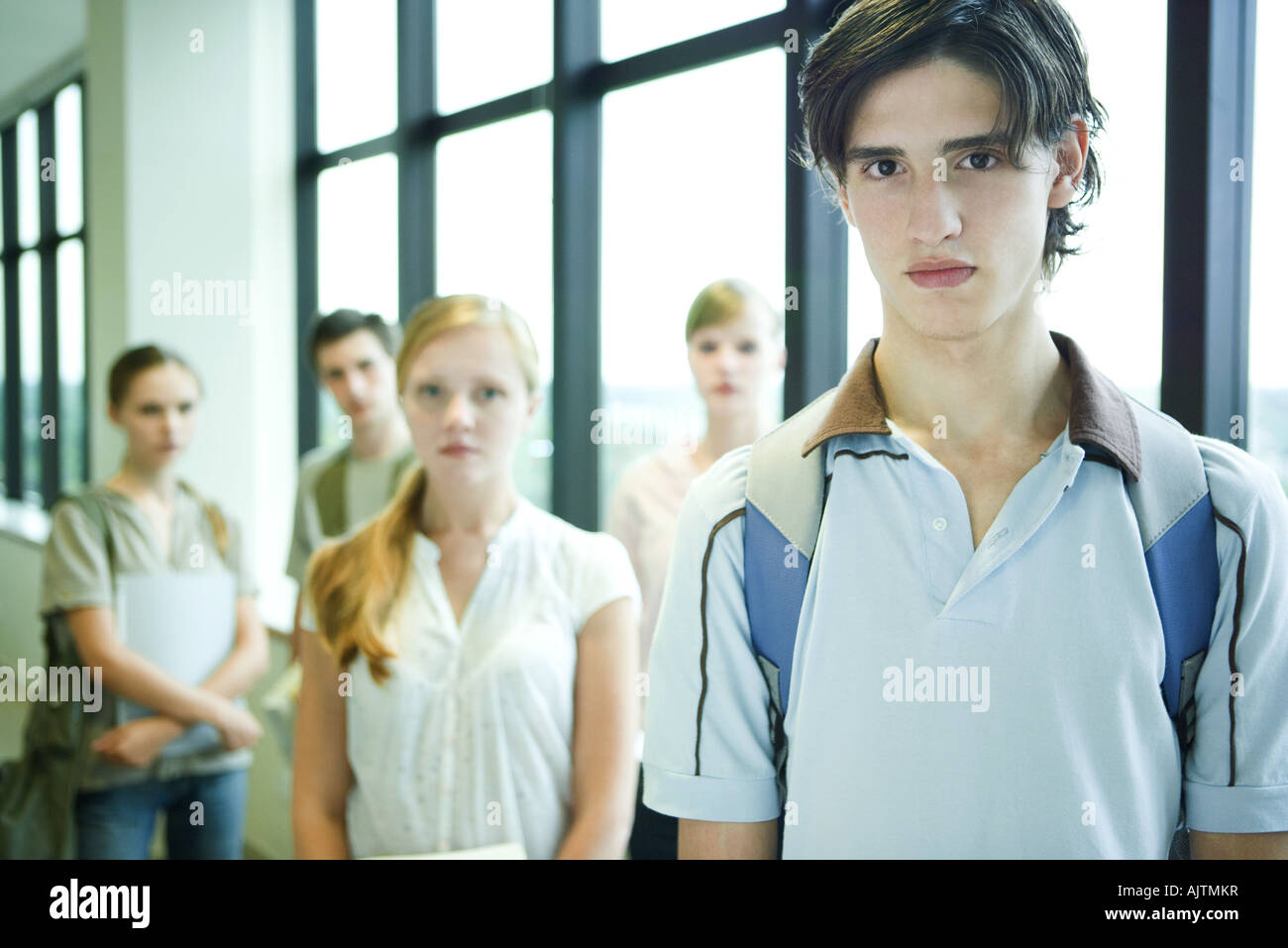 Student Camera Man Group of college students looking at camera, focus on young man in ...