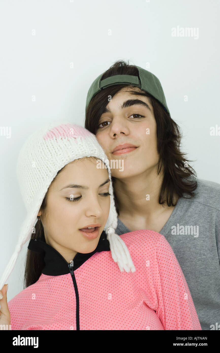 Portrait of young couple, both wearing hats, male smiling at camera, female looking away Stock Photo