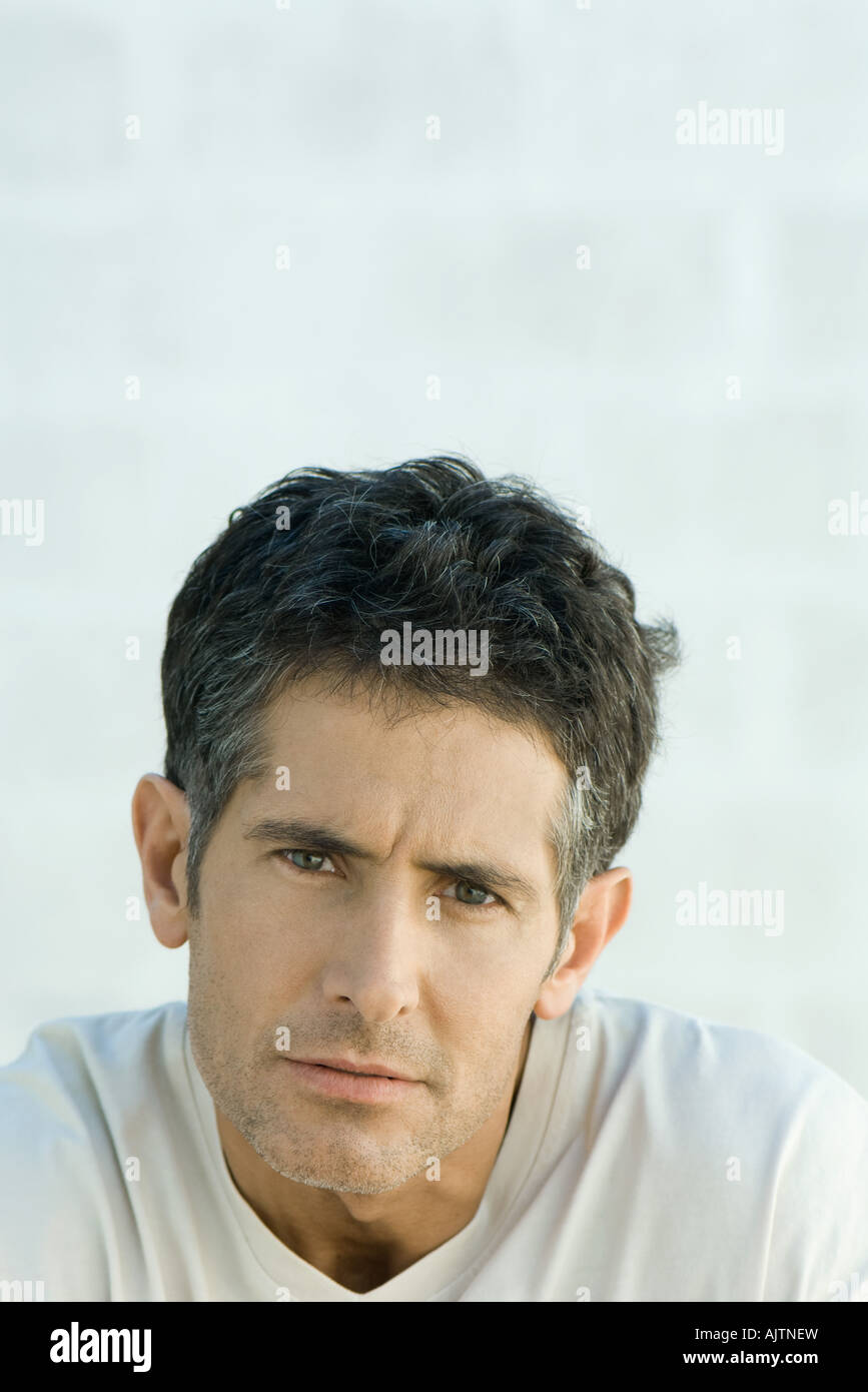 Mature man furrowing brow, looking at camera, portrait Stock Photo