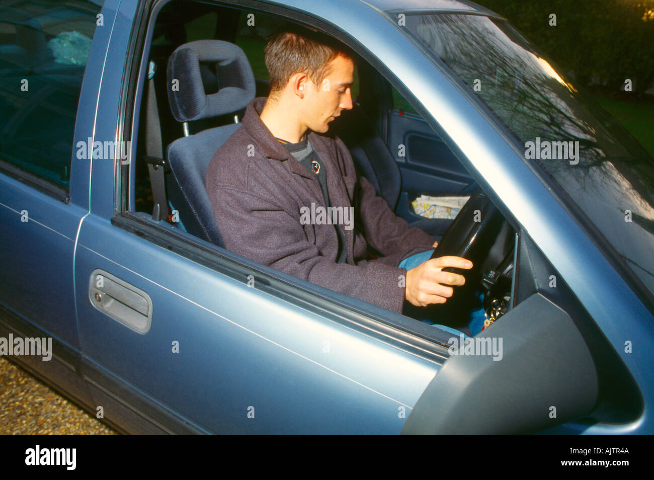 Young Man At Wheel Of Car Stock Photo