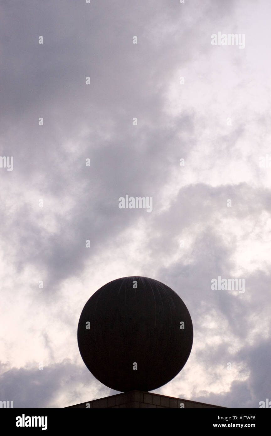 geometrical sculpture against cloudy sky barcelona spain Stock Photo