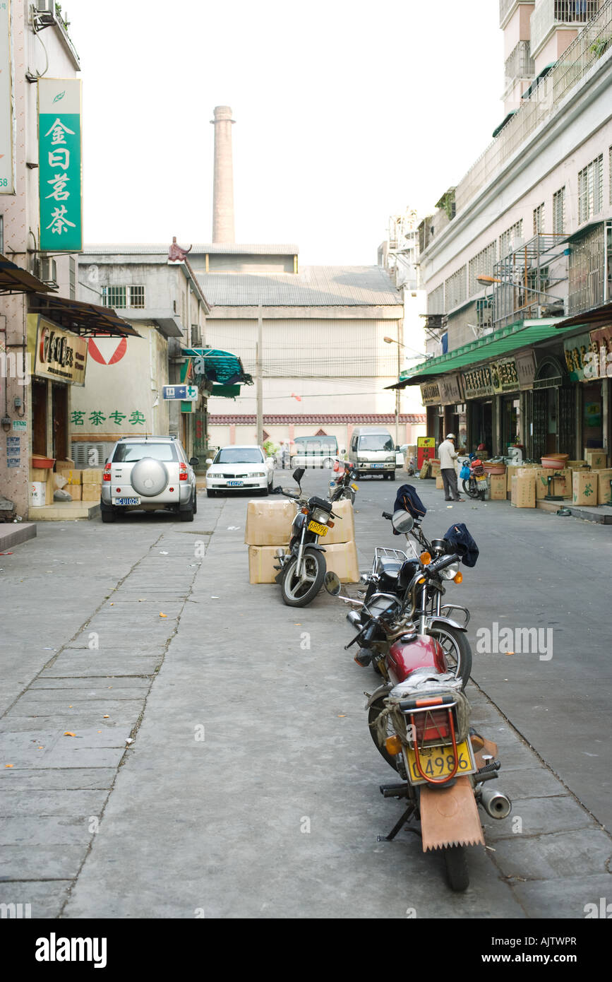 China, Guangdong Province, Guangzhou, motorcycles parked in street Stock Photo