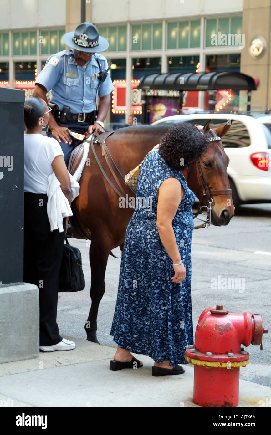 Tourists talk to policeman riding horseback Chicago city centre