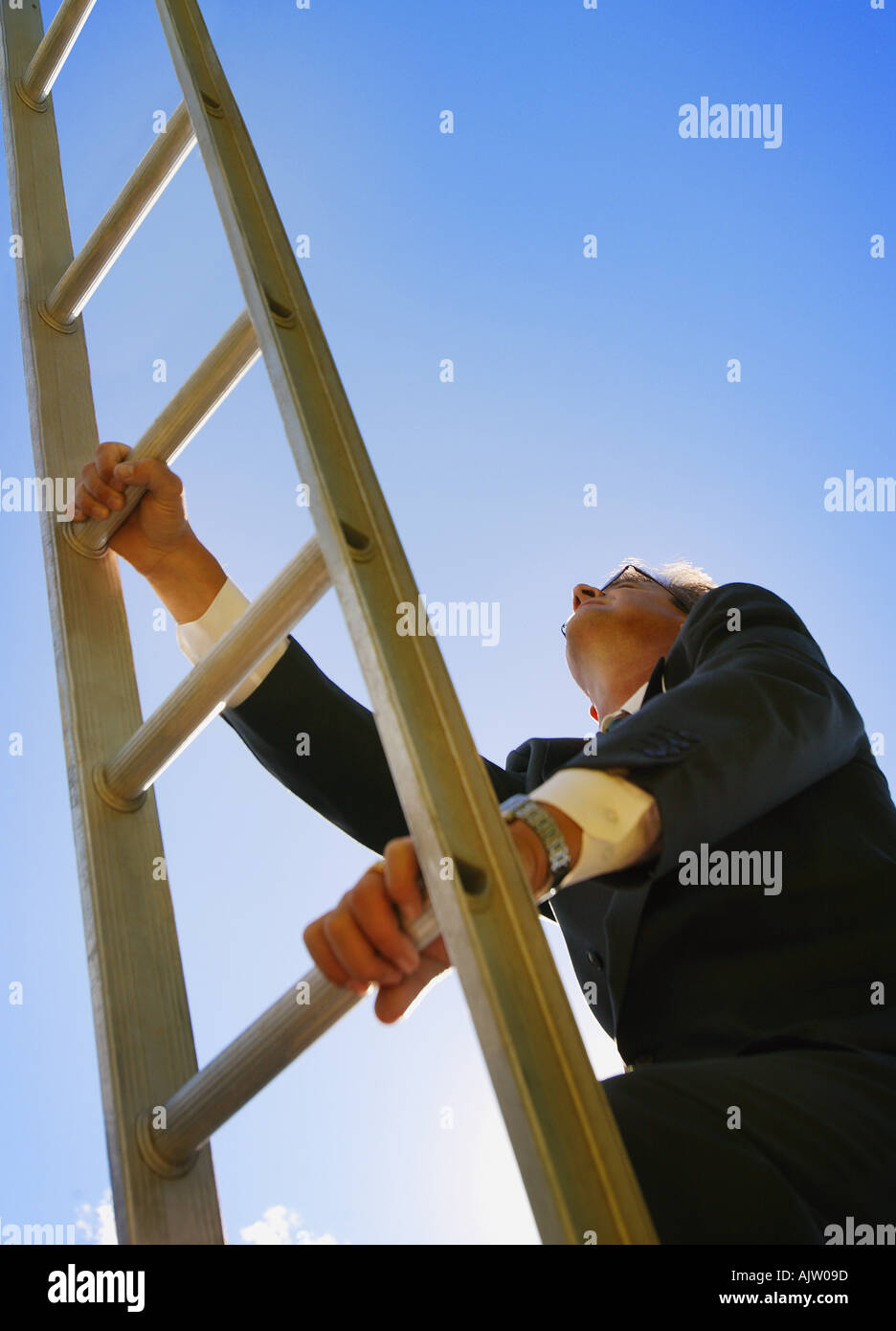 Businessman climbing ladder Stock Photo - Alamy