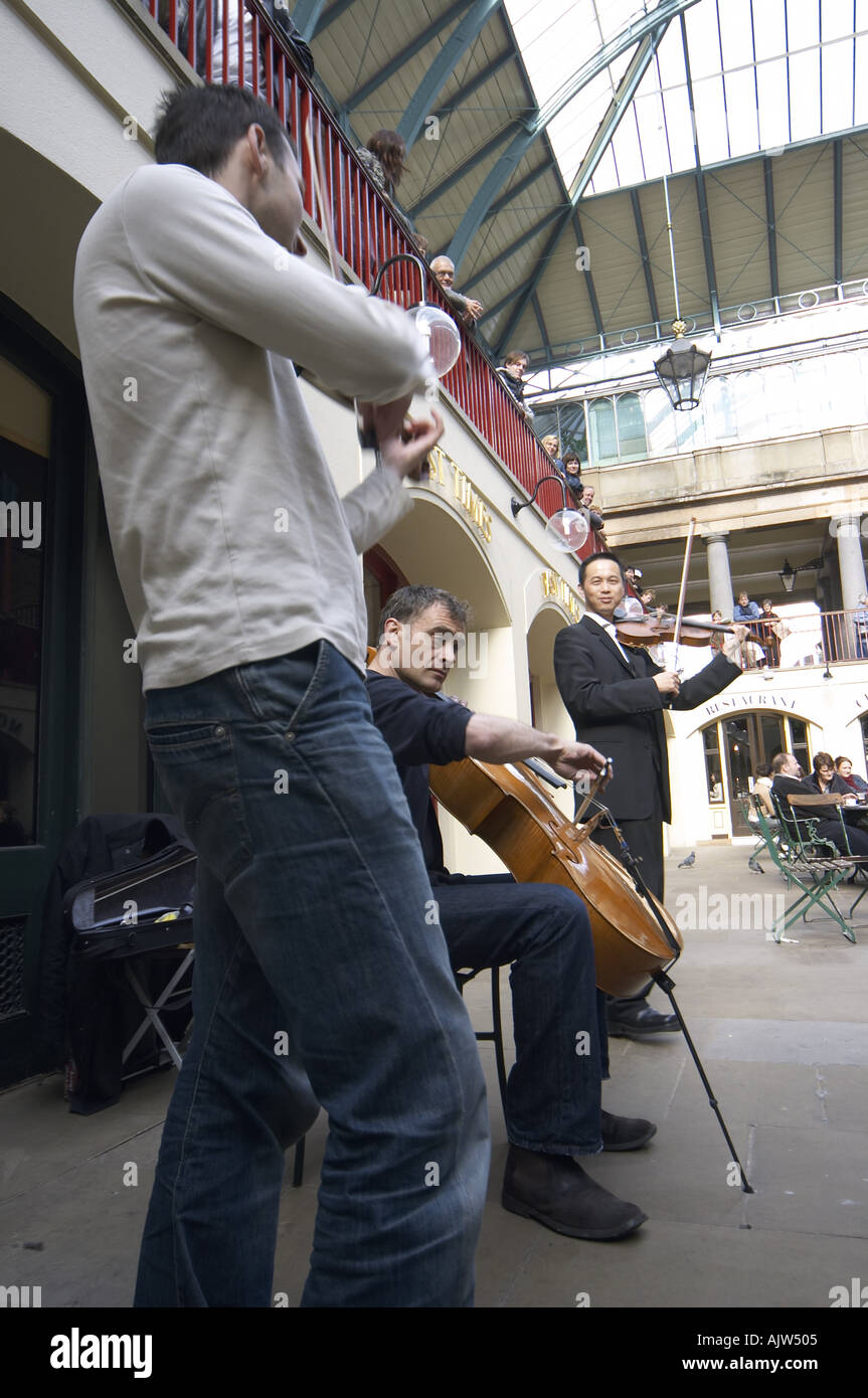 Busker musicians playing string instruments Covent Garden Market London ...
