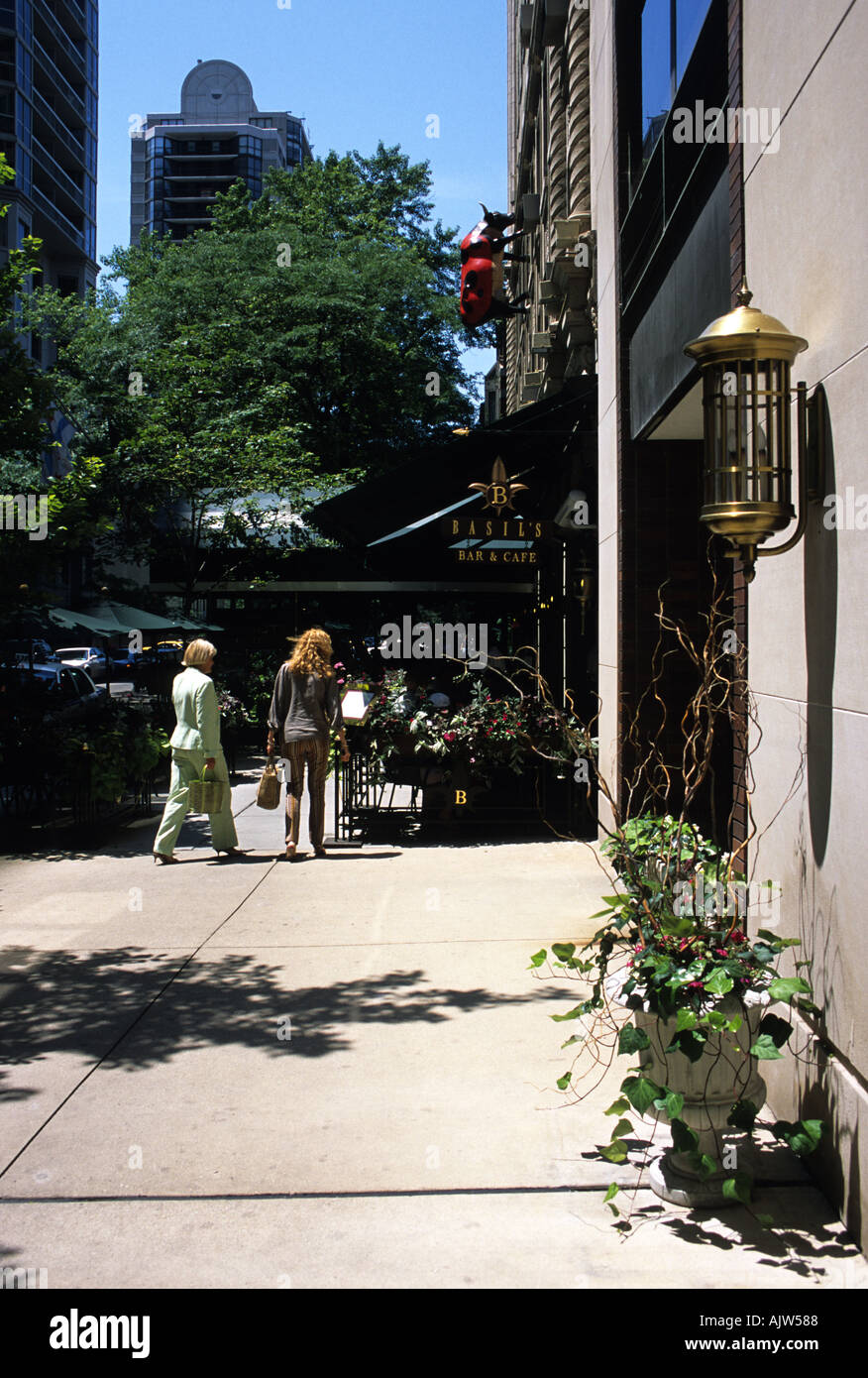 Chicago two woman walking towards Basils Bar and Cafe Stock Photo Alamy
