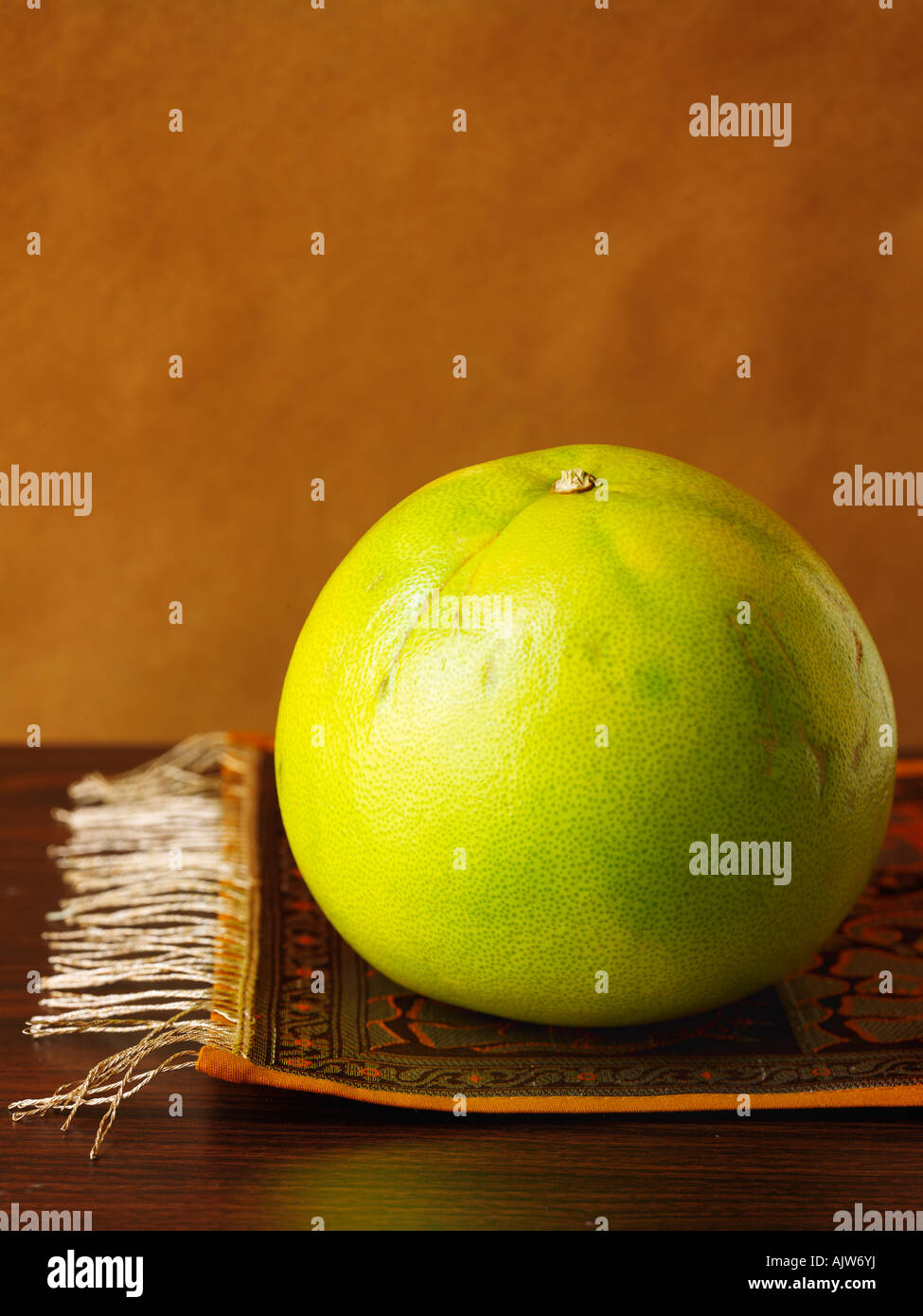 Whole Pomelo on Brown Background Stock Photo