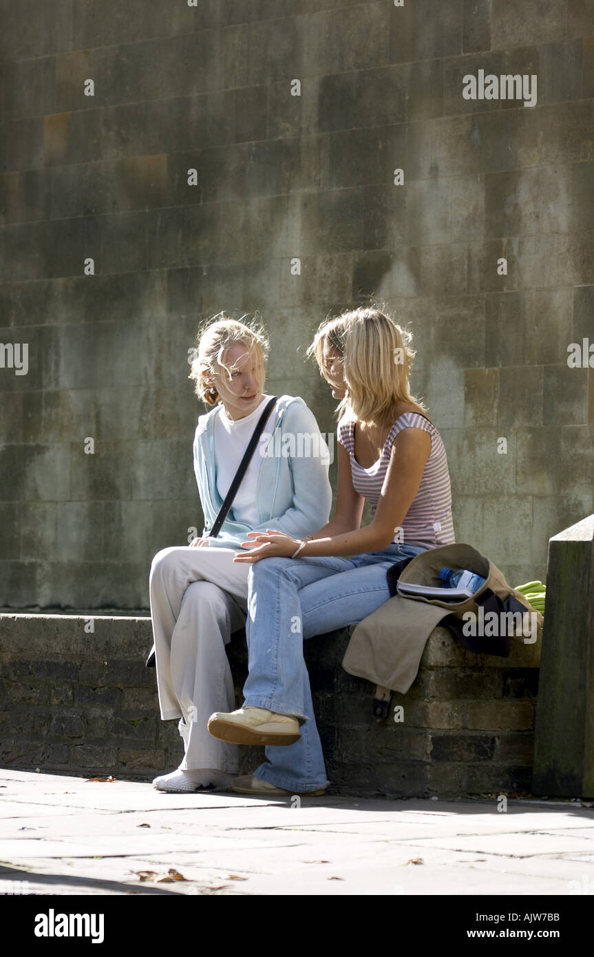 Two laughing girls sitting on hi-res stock photography and images - Alamy