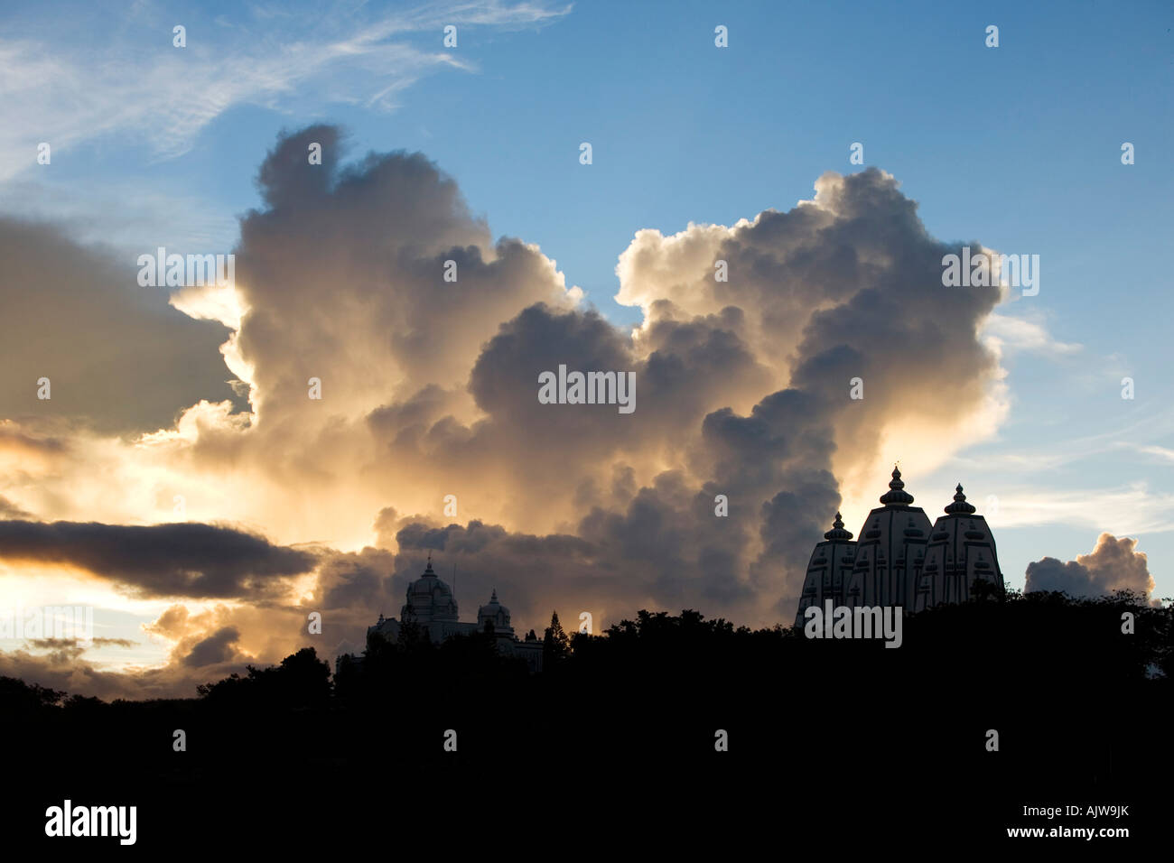 Sunset storm clouds over Indian ashram buildings. Puttaparthi, Andhra Pradesh, India Stock Photo