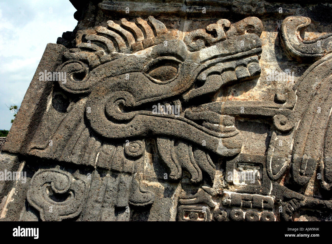 Ancient stone serpent deity carving/sculpture on a Mayan pyramid at Xochicalco archeological site. Stock Photo