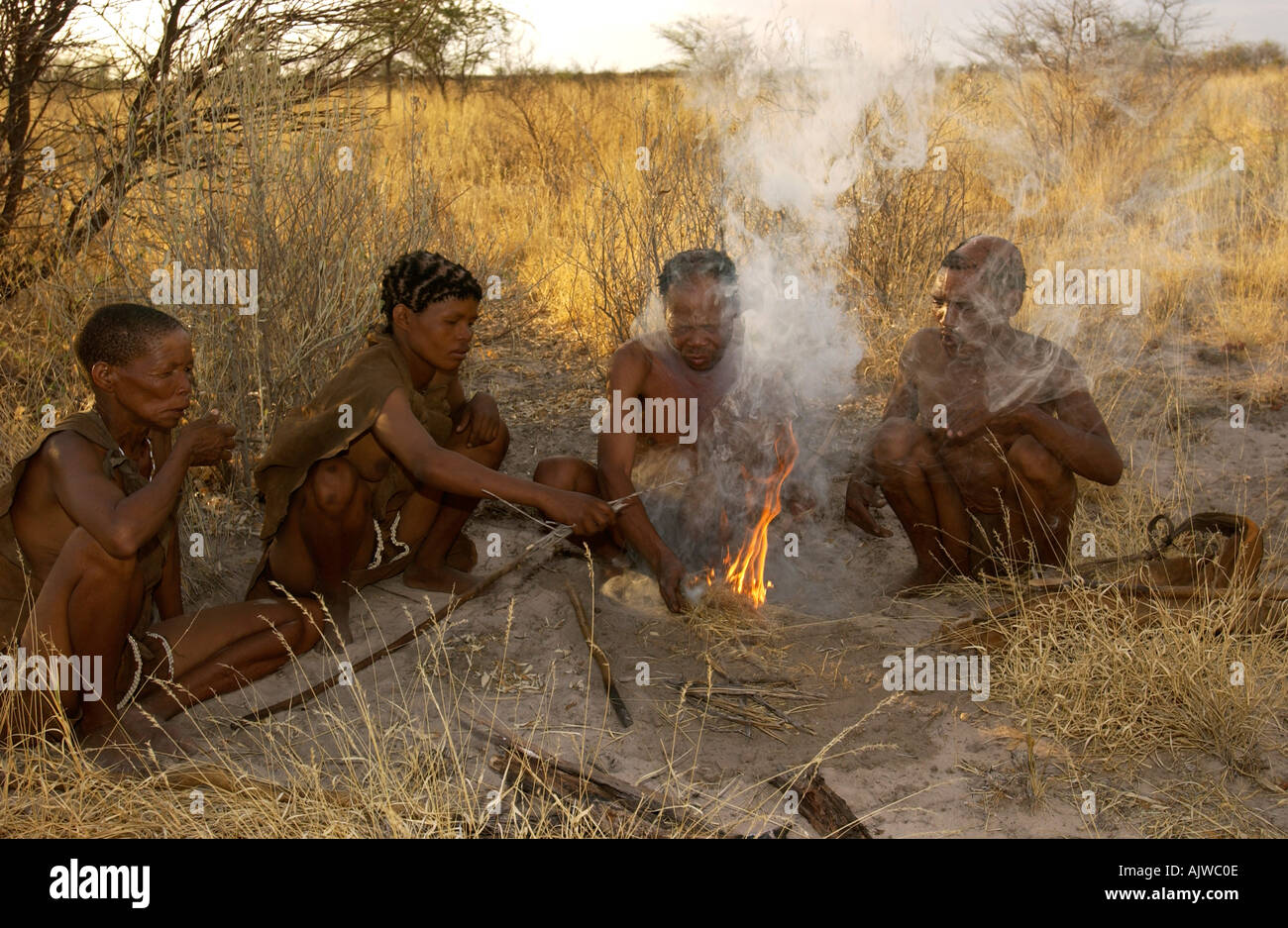 San Family Making Fire in the Kalahari Stock Photo