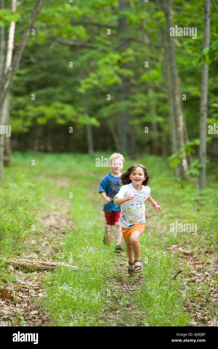 Young children age 5 on a trail in the forest near Marquoit Bay in