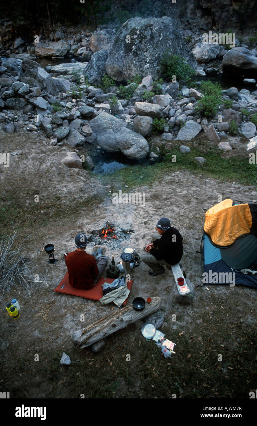 Campers sitting round camp fire, Copper Canyon Mexico Stock Photo Alamy