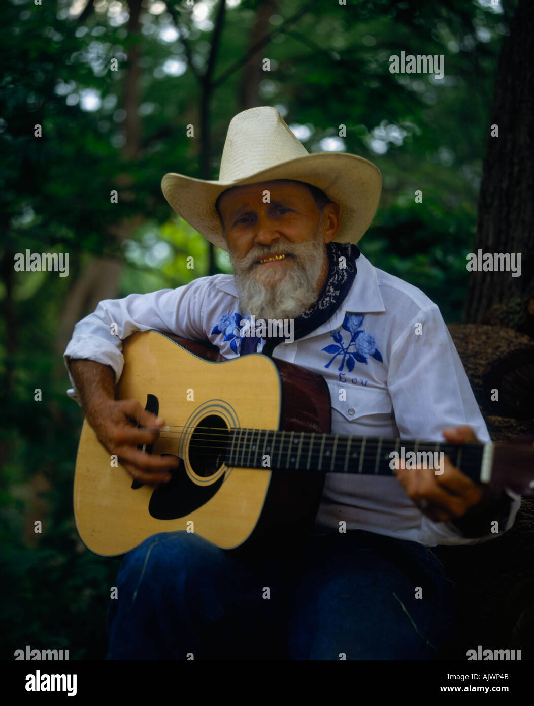 Portrait of singing cowboy with guitar and wearing traditional hat at Mayan Ranch Banderal Texas USA Stock Photo