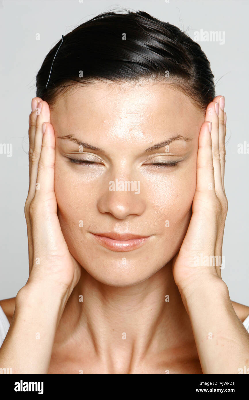 young woman stretching the skin of her face Stock Photo