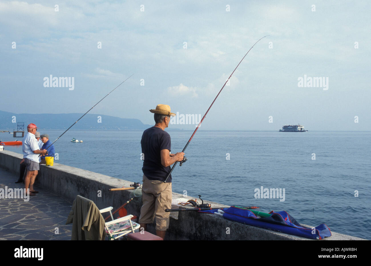 Anglers at the harbour in Toscolano Maderno Garda Lake Italy Europe Stock Photo