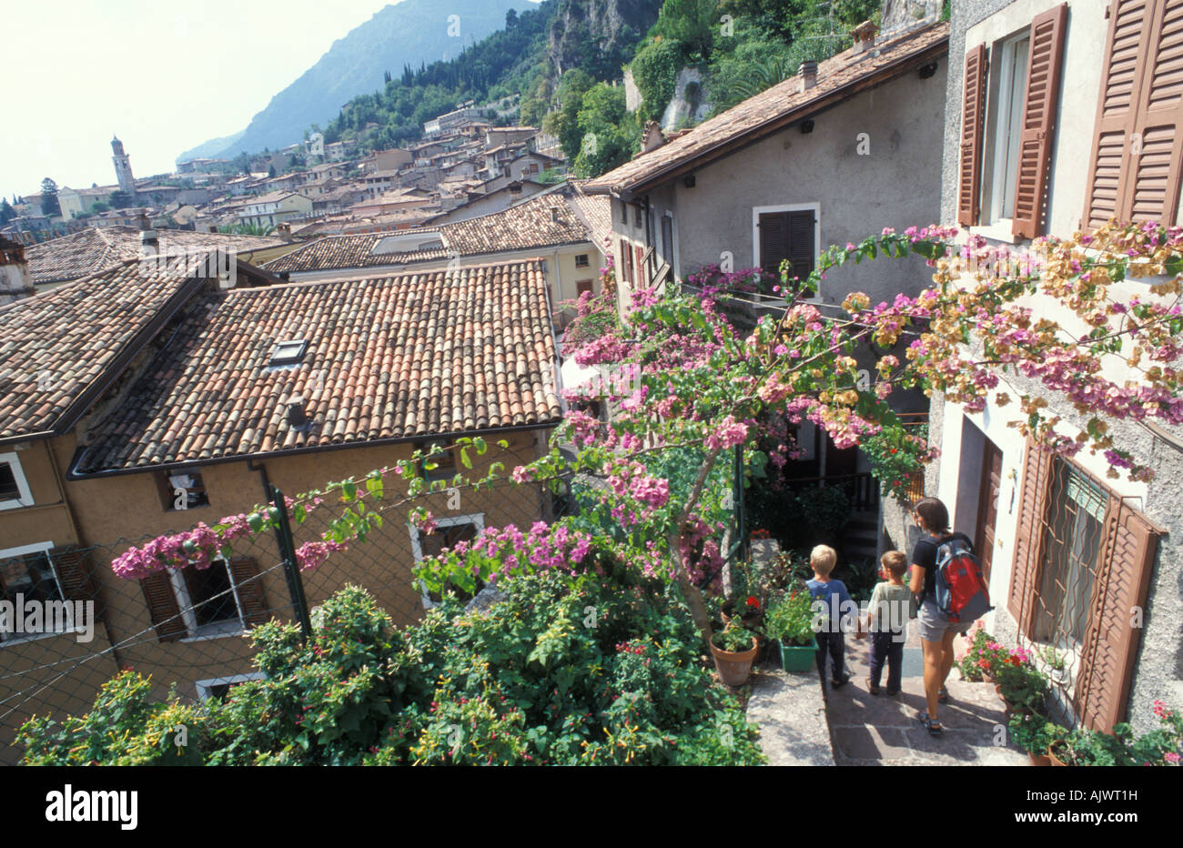 Woman with two children walking through an alley in Limone Garda Lake Italy Europe Stock Photo