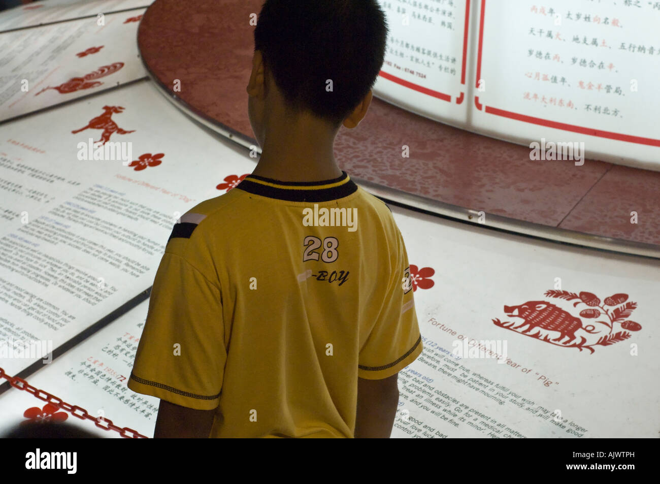 Reading the Lunar New Year predictions in Singapore Stock Photo Alamy