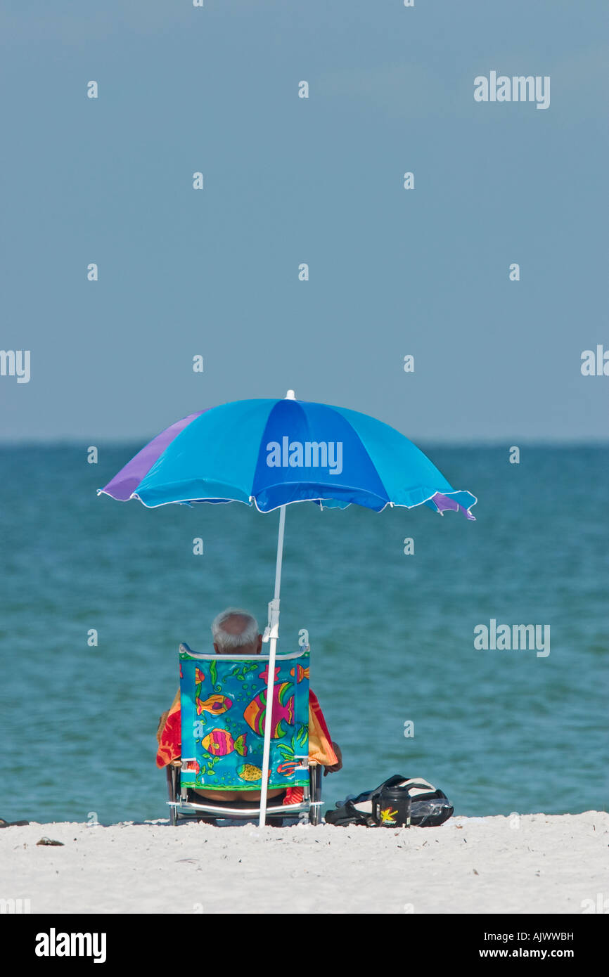 Man relaxing at the Beach vertical Stock Photo - Alamy