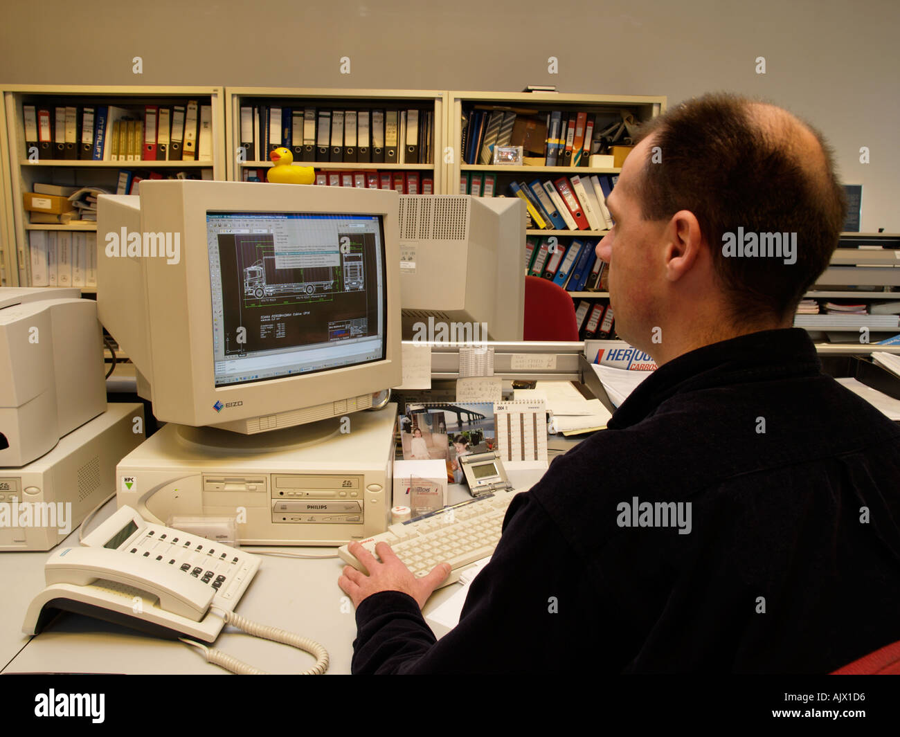 Man Working In An Office At A Cad Cam Design System Pc Computer