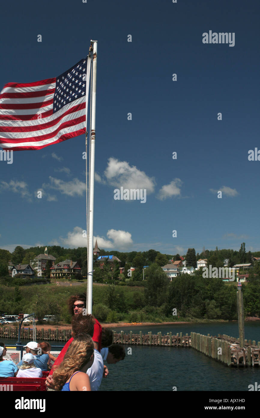 American Flag Flys over Deck of Tourist filled Ferry Stock Photo