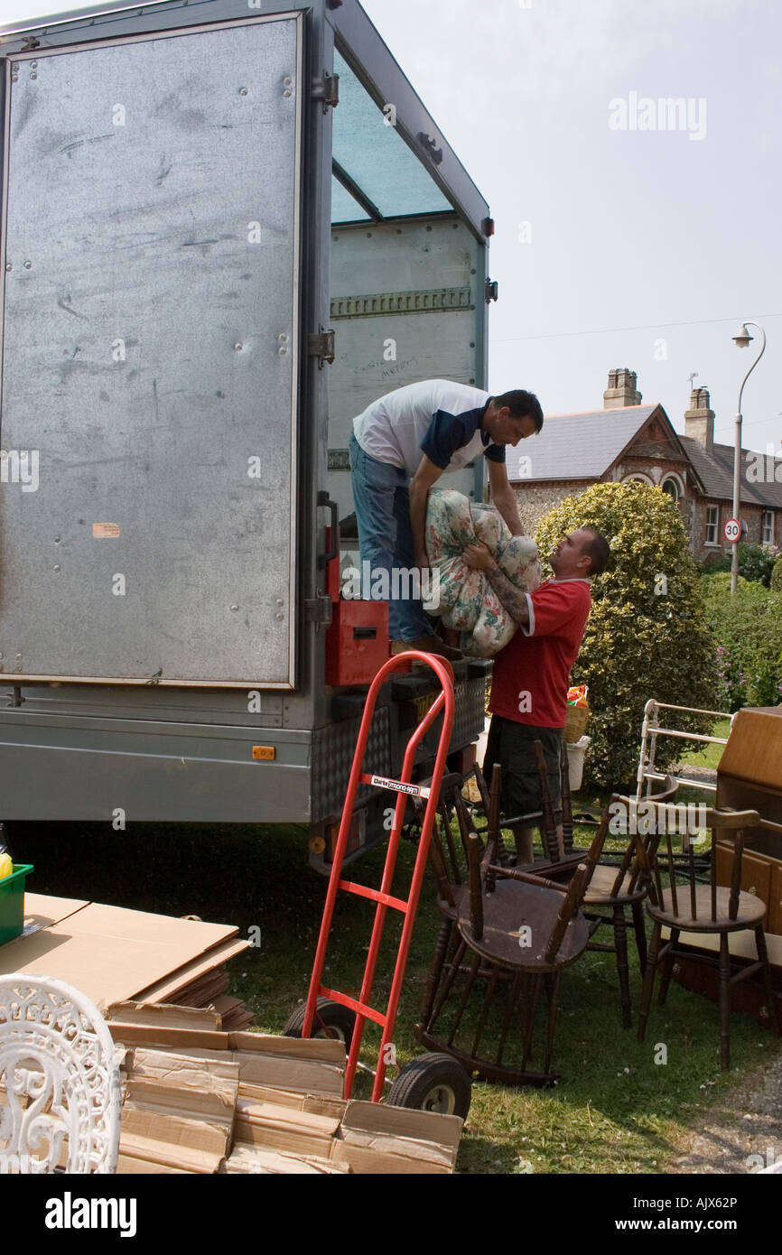 two men loading van with household contents Stock Photo