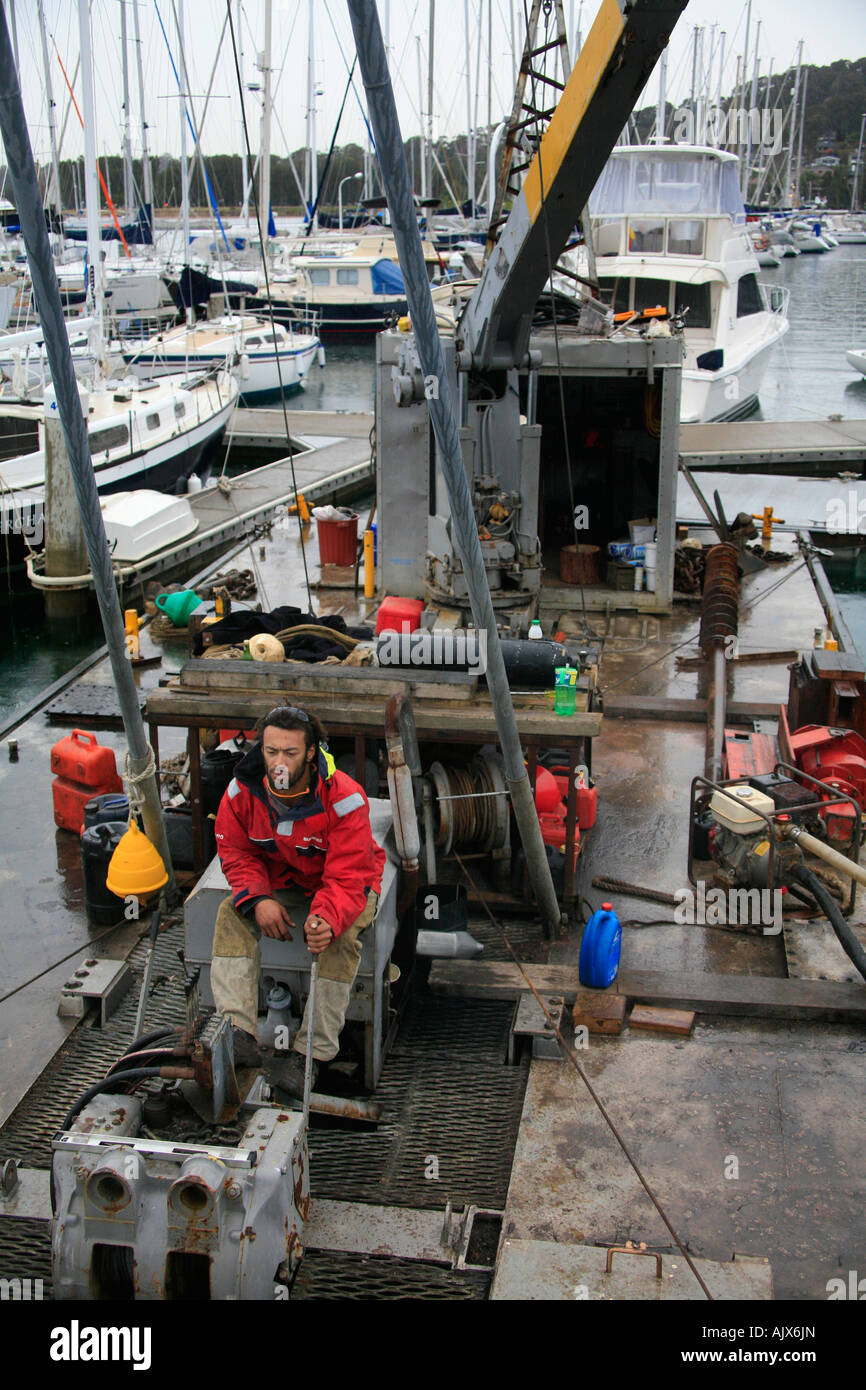 A man operates a winch on a drilling rig Stock Photo Alamy