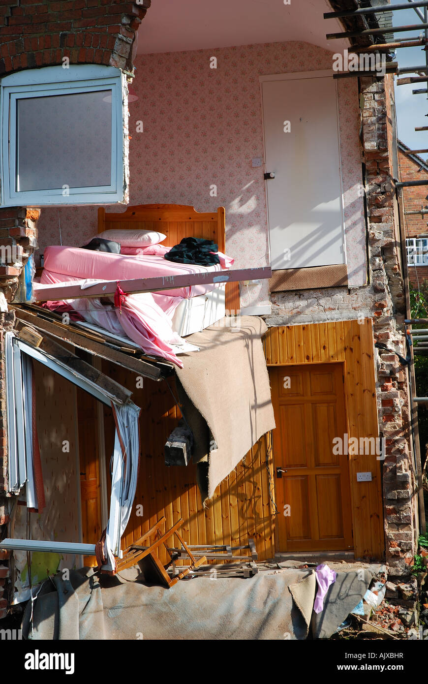 Ludlow, England, UK: bed hangs in mid-air in collapsed corner of a house caused by severe flooding June 2007 Stock Photo