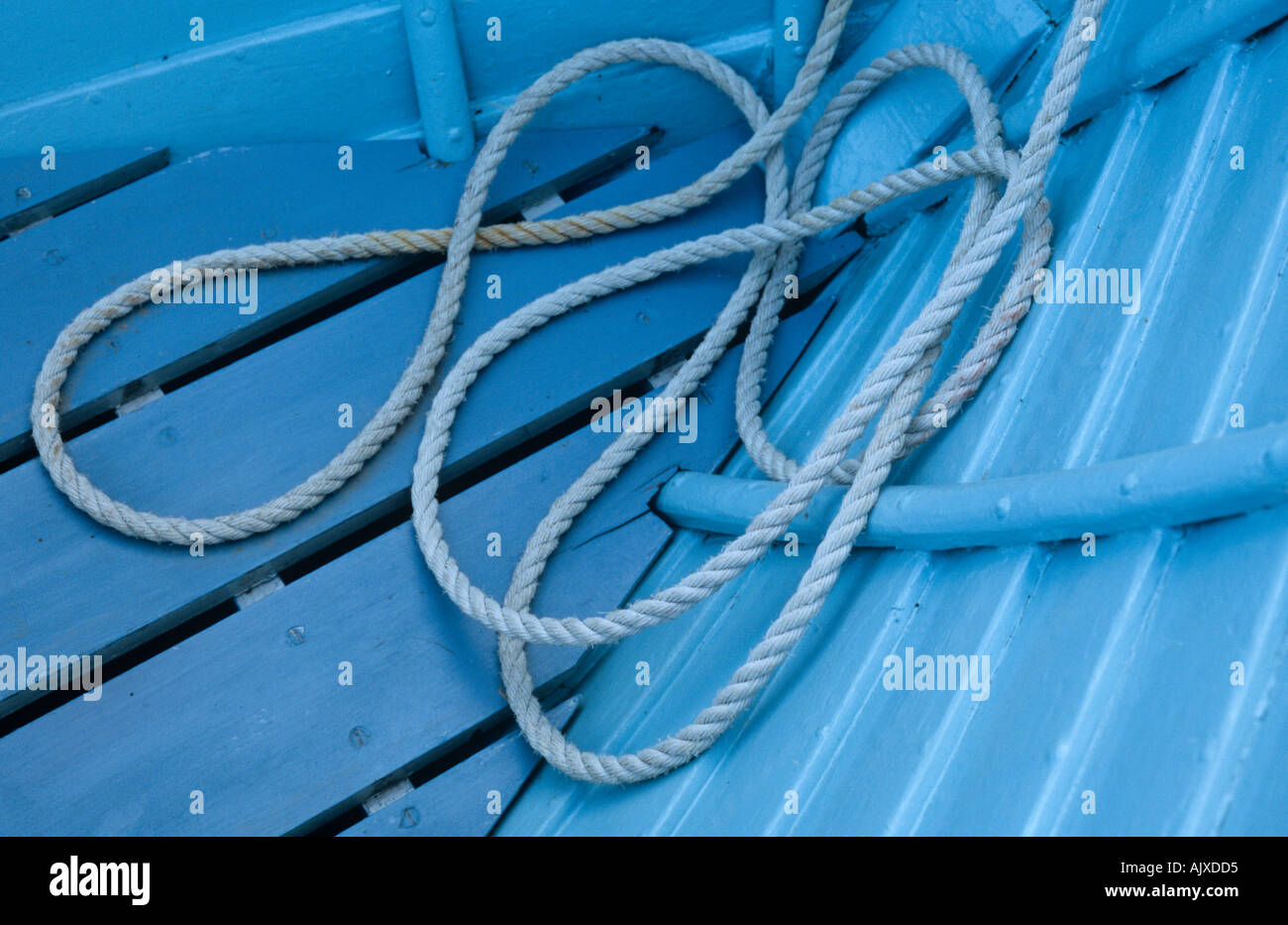 Blue rope lying in small blue boat Stock Photo - Alamy