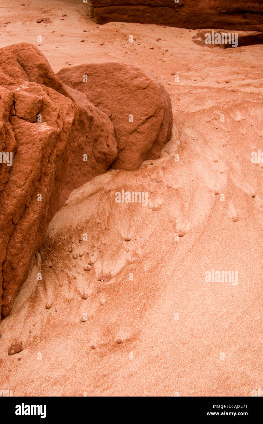 Beach sand and red rocks with runoff patterns, Campbell's Cove, PE/PEI, Canada Stock Photo